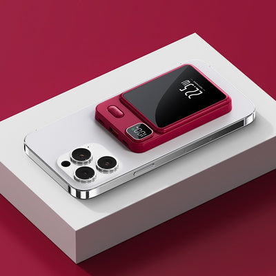 Red magnetic power bank for smartphones attached to silver smartphone on white platform