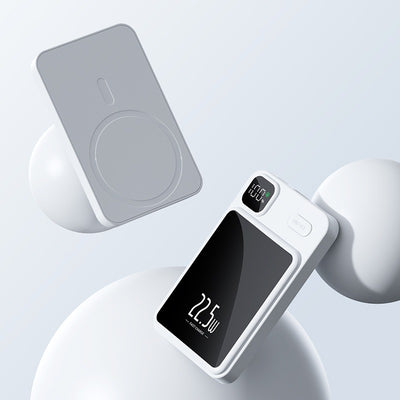 White magnetic power bank for smartphones with digital display showing charging wattage